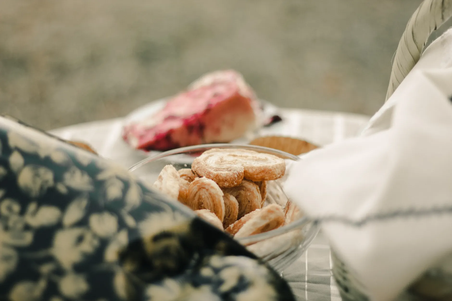 Delicious and flaky palmiers in a glass bowl on a beautifully set table, perfect for gourmet food settings.